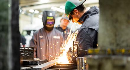 student in welding helmet