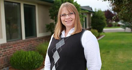 Adult student in front of CSI sign