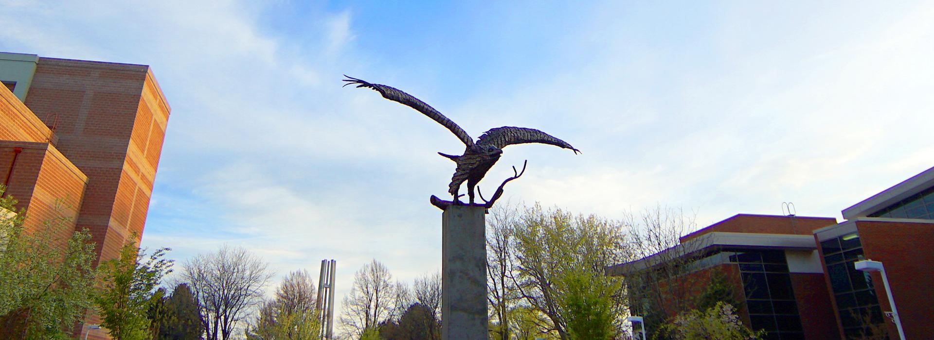 Eagle statue with blue sky and building behind