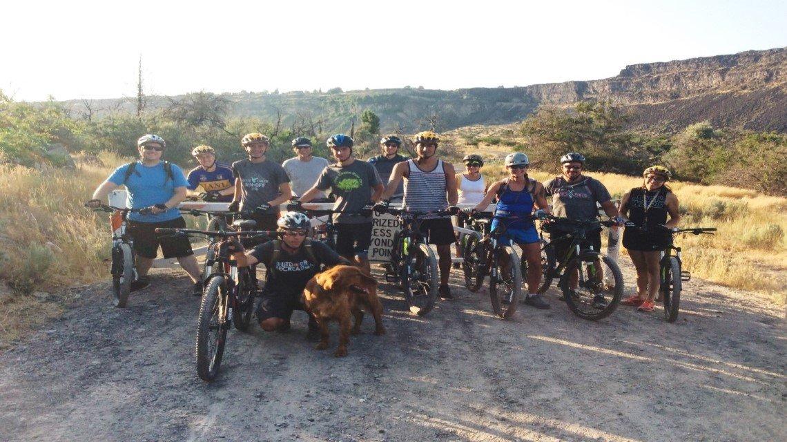 A large group of students gathers for a picture before their bike ride