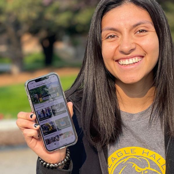 woman holding a phone showing CSI mobile app 