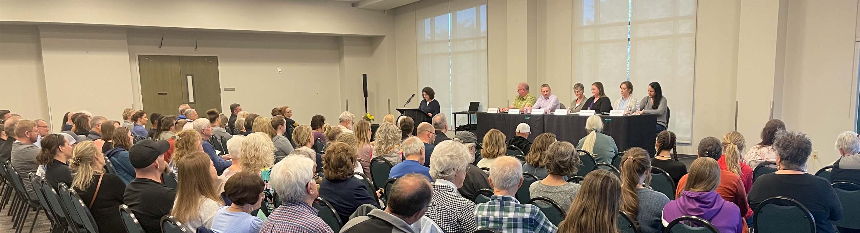 auditorium of people listening to a panel 
