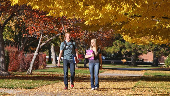Two students walking on campus